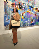 Woman's Art Journal Editor, Art Historian, and curator Aliza Edelman carrying a Woman's Art Journal tote