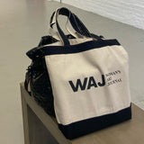 Woman's Art Journal Tote bag pictured on a gallery bench